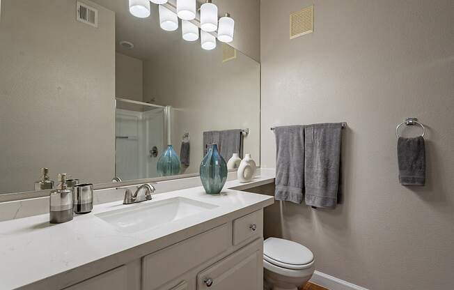 A bathroom with a white counter top and a white toilet.at Palazzo Townhomes, Arizona, 85008