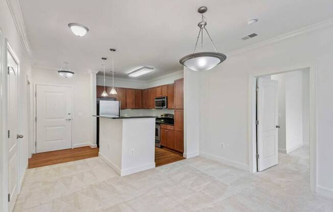 an empty kitchen with a counter top and a refrigerator