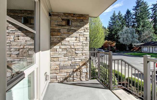 a balcony with a view of a street and trees at Delano, Washington