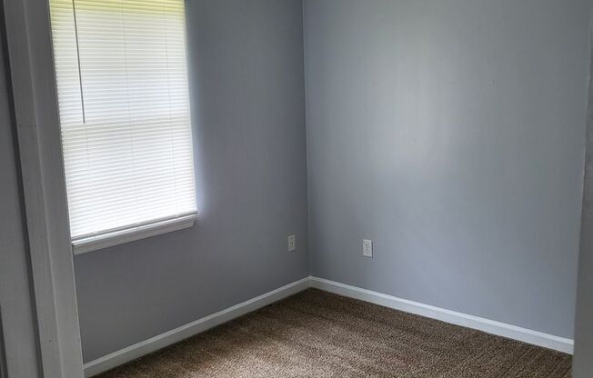 Single family home with covered front porch and back patio.