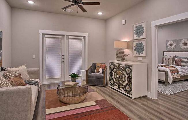 a living room with furniture and a ceiling fan at Hunters Creek Apartments, Denton