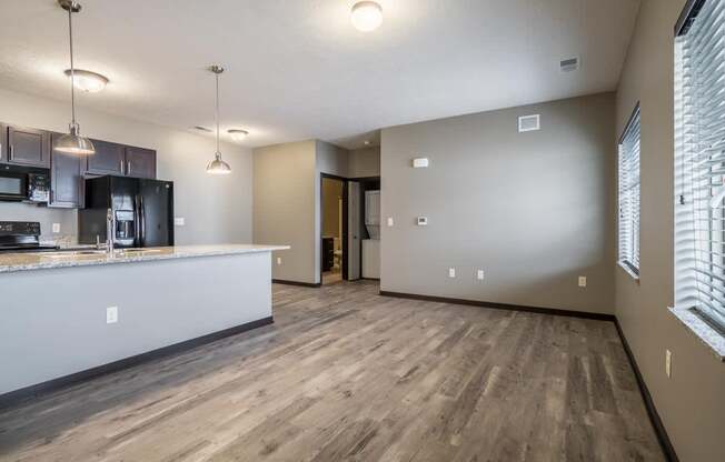 Kitchen and living room with LVT floors and large windows