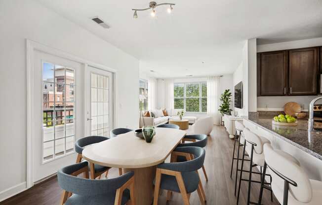 a living room and kitchen with a dining table and chairs at Aspire Apollo, Camp Springs
