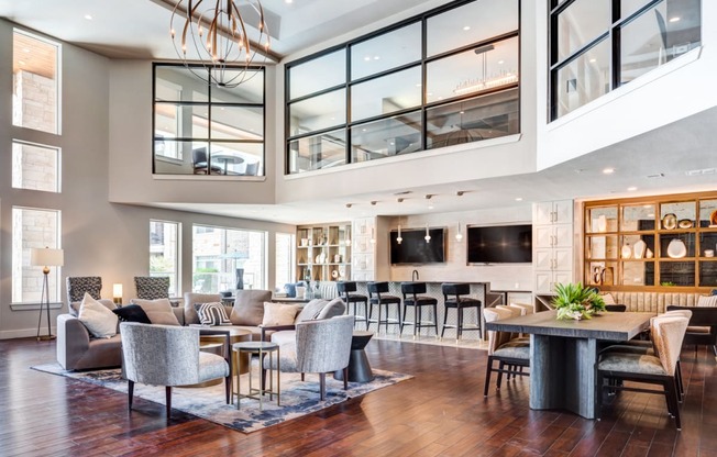 a living room filled with furniture and a large chandelier