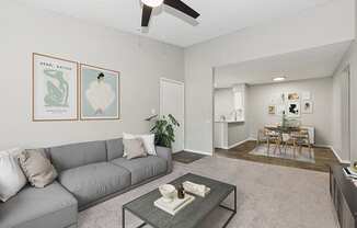 Model Living Room with Carpet and View of Kitchen/Dining Area at Grand Pavilion Apartments in Tampa, FL.