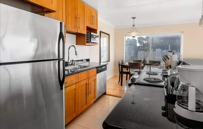 a kitchen with wooden cabinets and stainless steel appliances