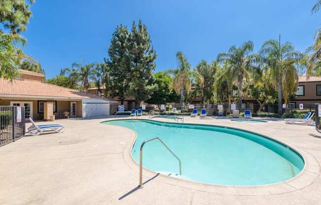 our resort style swimming pool is next to our buildings and trees