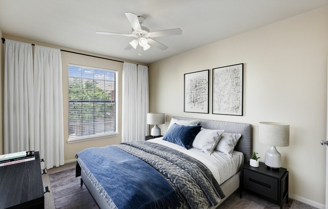 View of Enclave on Golden Triangle Bedroom with Bed, Side Tables, Lamps and a Large Window