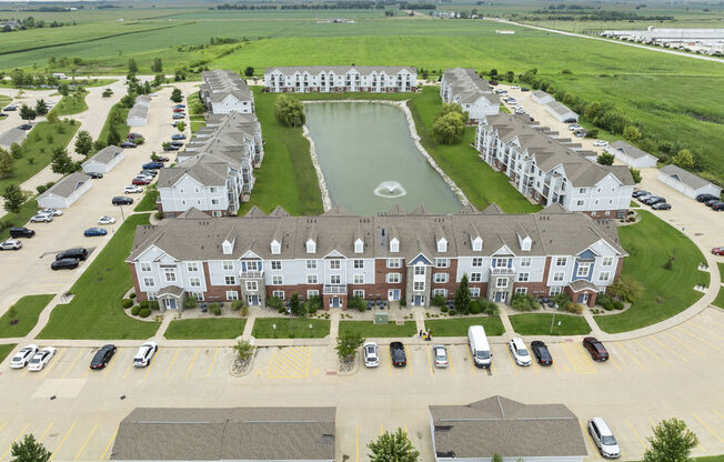 an aerial view of an apartment community with a pond at Hunters Pond Apartment Homes, Champaign, 61820