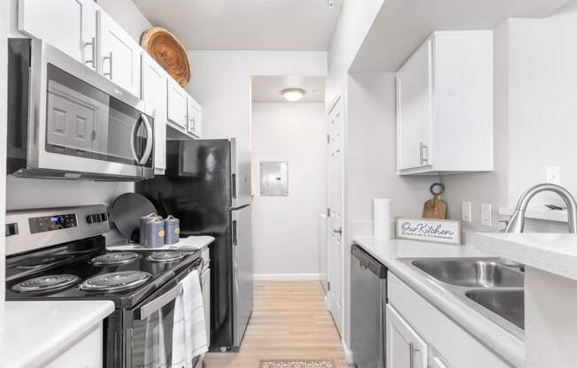 a kitchen with stainless steel appliances and white cabinets