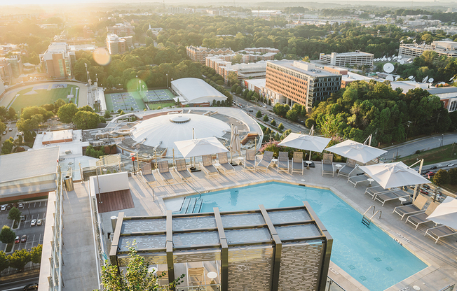 Sky view of L shaped pool area with cabana seating