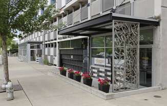 View of the property entrance from the side with artsy iron patio wall at Villaggio Apartment Homes, Tacoma, Washington 98402