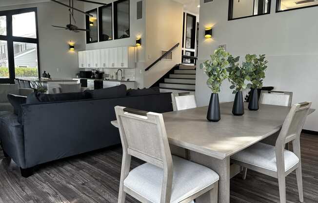 a dining room and living room with a table and chairs