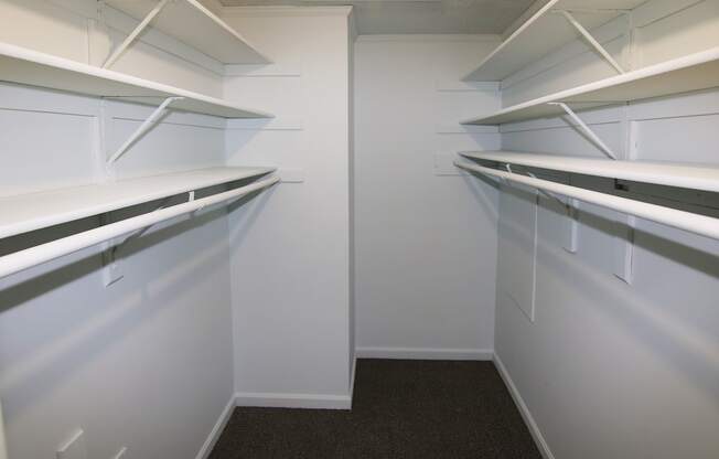 Empty white shelves in a room.