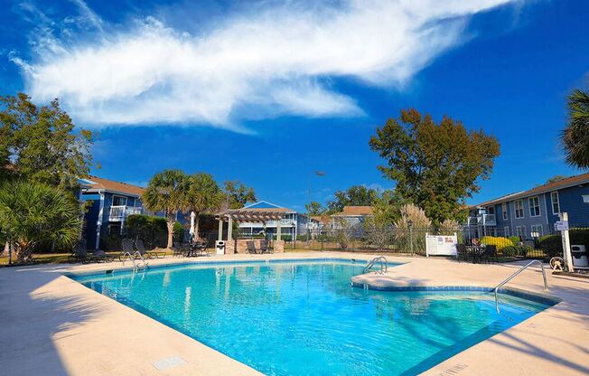 a large swimming pool with a blue sky above it