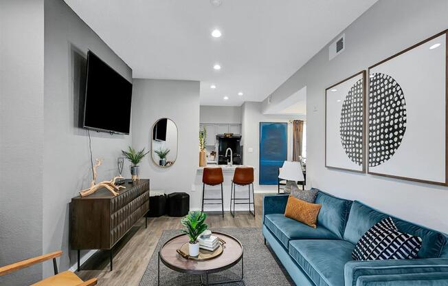 a living room with a blue couch and a tv