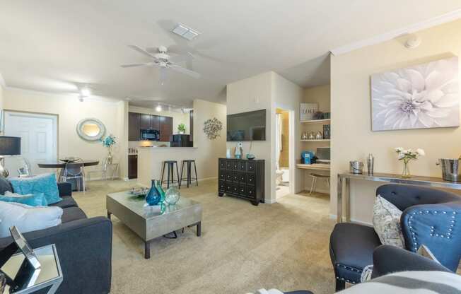 a living room with furniture and a ceiling fan