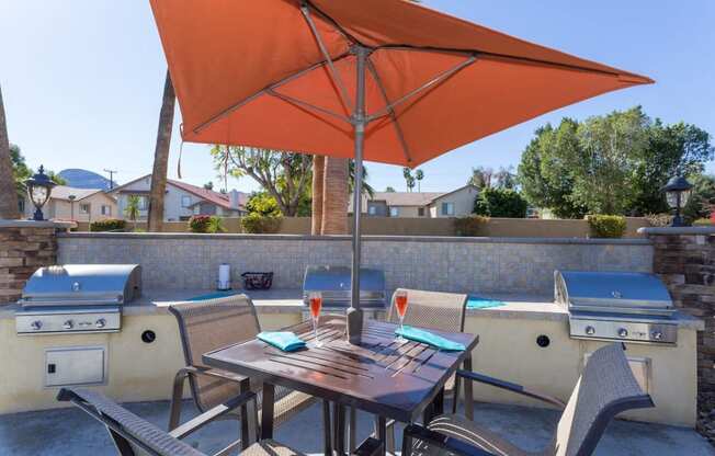 a patio with a table and chairs and an umbrella