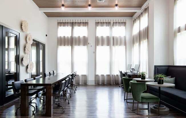 a large room with a table and chairs and windows