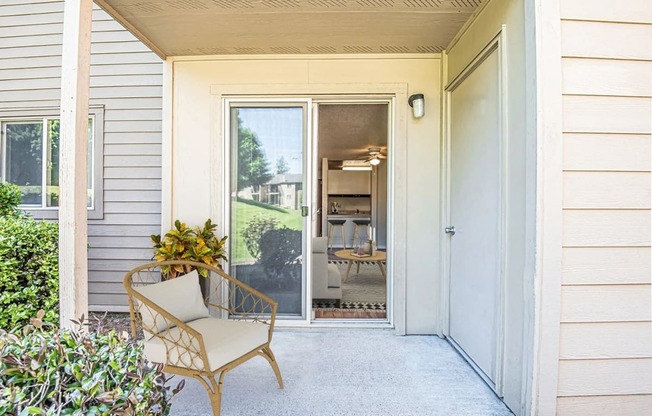 the front porch of a house with a chair and a door at Eagles Landing Apartments, Everett, 98204