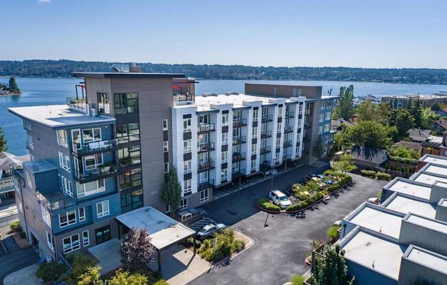 an aerial view of an apartment building with a lake in the background at Spyglass Hill Apartments, Washington 98337
