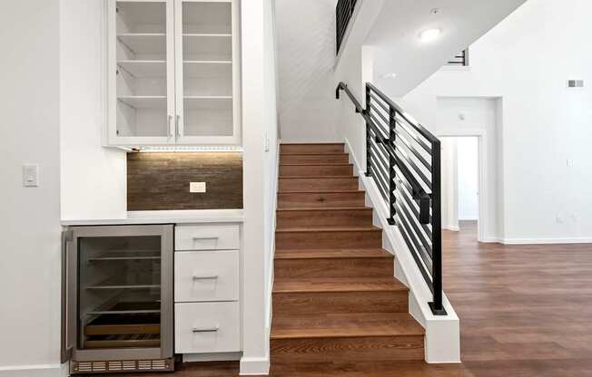 a view of a staircase in a home with white walls and wood floors