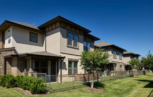 A row of houses with a clear blue sky above them.