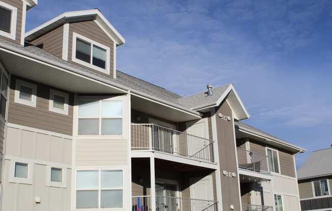 a view of a building with a balcony and a blue sky
