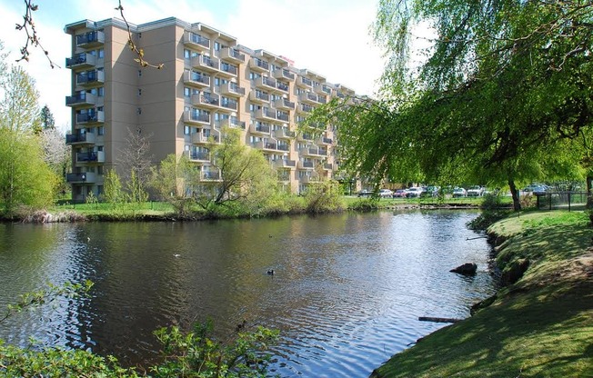 A large building with a lake in front of it.
