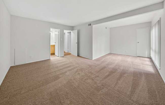 A room with carpeted floor and white walls.