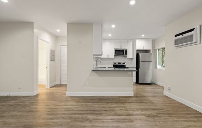 a kitchen with a stove and a refrigerator