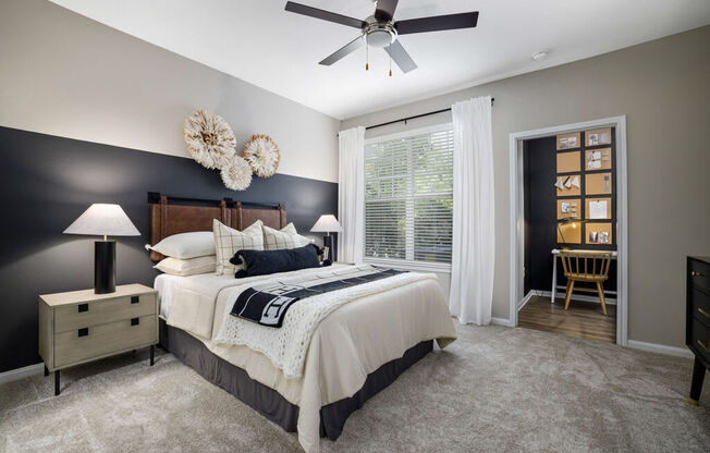 a bedroom with a bed and a ceiling fan