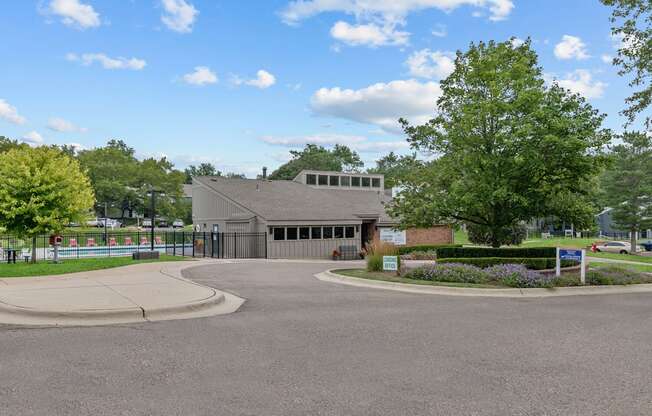a building with a gray roof and a roundabout in front of it