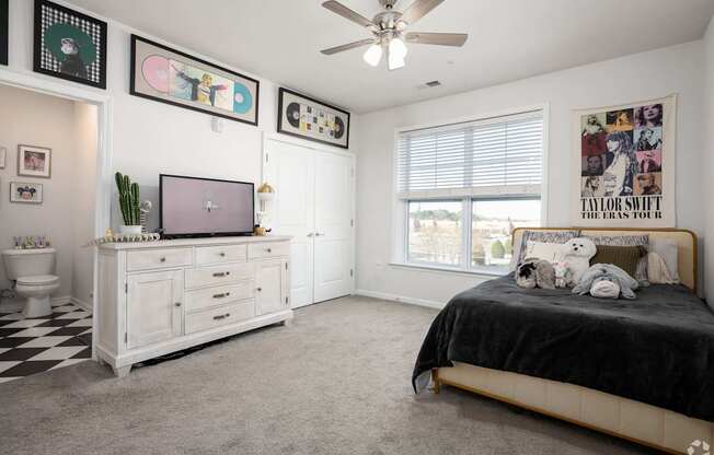 A Taylor Swift poster is on the wall above the bed in the bedroom.