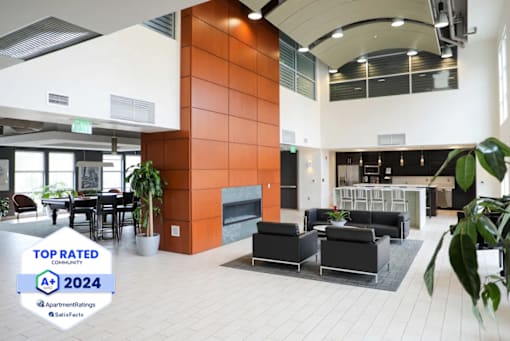 Metro Crossing Apartments Clubhouse Interior with Resident Satisfaction Logo Banner