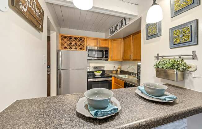 a kitchen with stainless steel appliances and a counter with two cups
