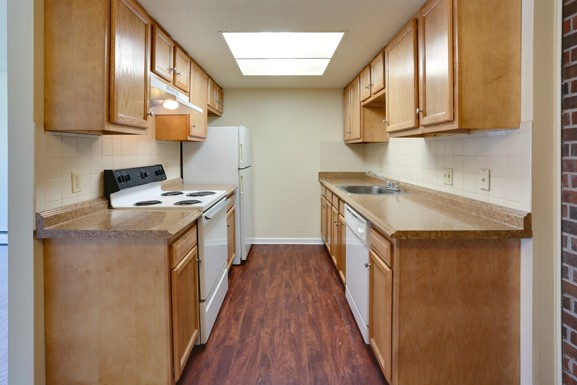 a kitchen with wooden cabinets and a stove and a refrigerator