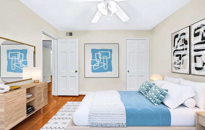 a bedroom with a large bed and a ceiling fan