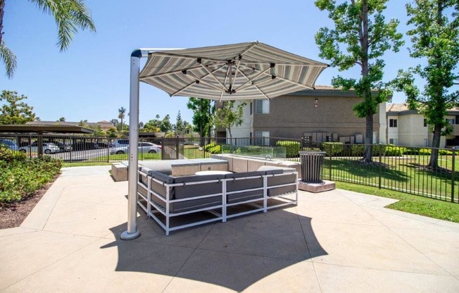 a fenced in area with a picnic table and an umbrella