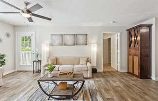 a living room with a couch and a ceiling fan