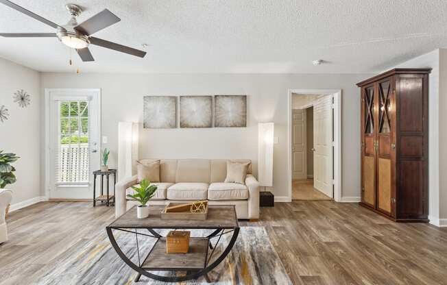 a living room with a couch and a ceiling fan