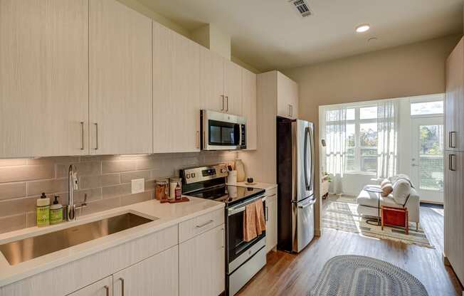 Large white cabinetry in kitchens - BLVD at Revere Beach