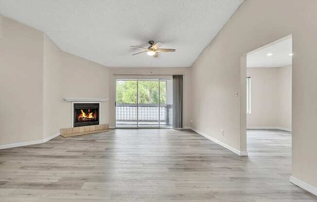 spacious living area with attached patio and fire place