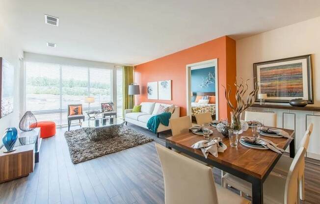 A dining room with a wooden table set for a meal.
