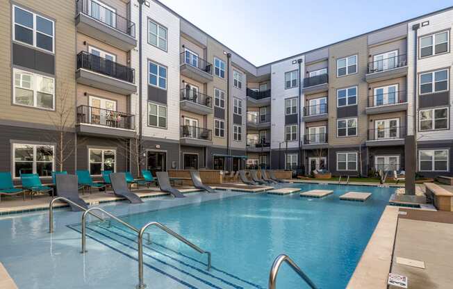 a swimming pool in front of an apartment building