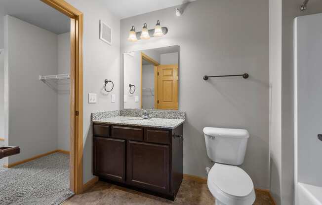 the ensuite bathroom with a shower and tub at the enclave at woodbridge apartments in sugar
