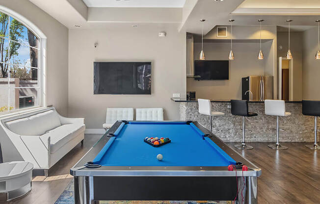 Community Clubhouse with Game Tables & Kitchenette Area at Reserve at Rancho Apartments located in Moreno Valley, CA.