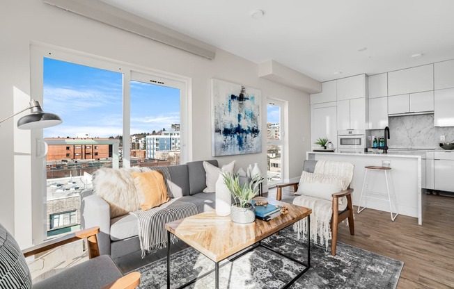 a living room with a couch and a coffee table and a kitchen  at Oslo, Seattle, WA, 98102