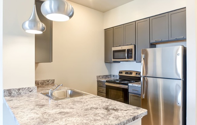 kitchen with stainless steel appliances and large breakfast bar at city view apartments in washington dc