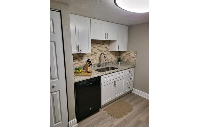 a kitchen with a sink and a refrigerator